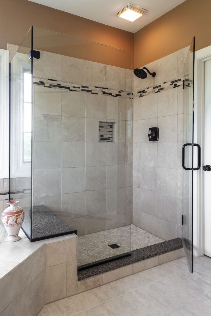 custom shower with mosaic tile accent