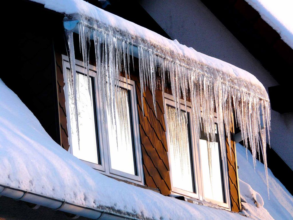Ice dams forming on gutters can cause winter storm damage