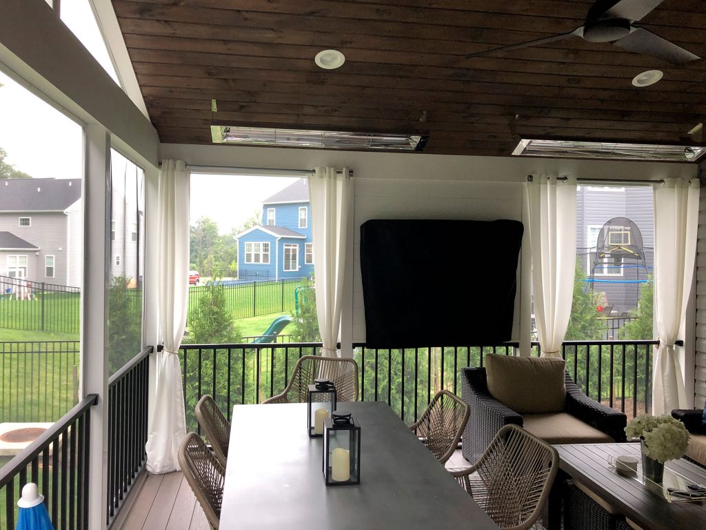 Screened in room with TV, a dining table, and lounging area in Baltimore area