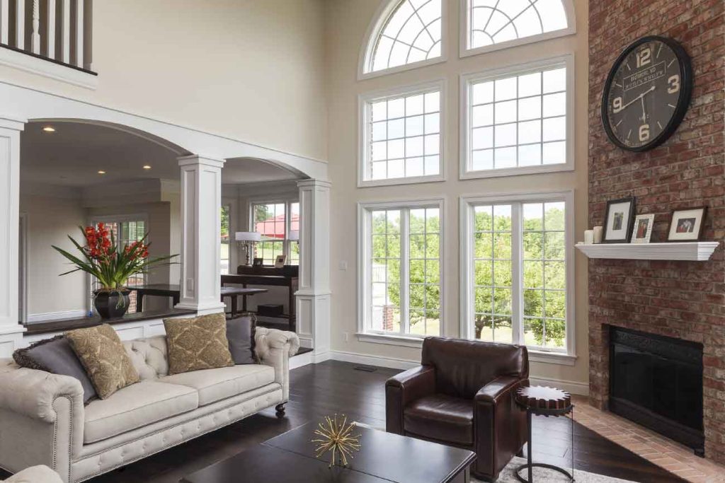 High ceilings and a floor to ceiling picture window make for a great statement piece in this traditional home