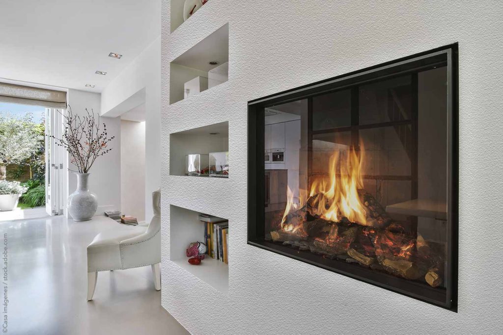 Modern fireplace as a statement piece with storage niches built into surrounding wall.