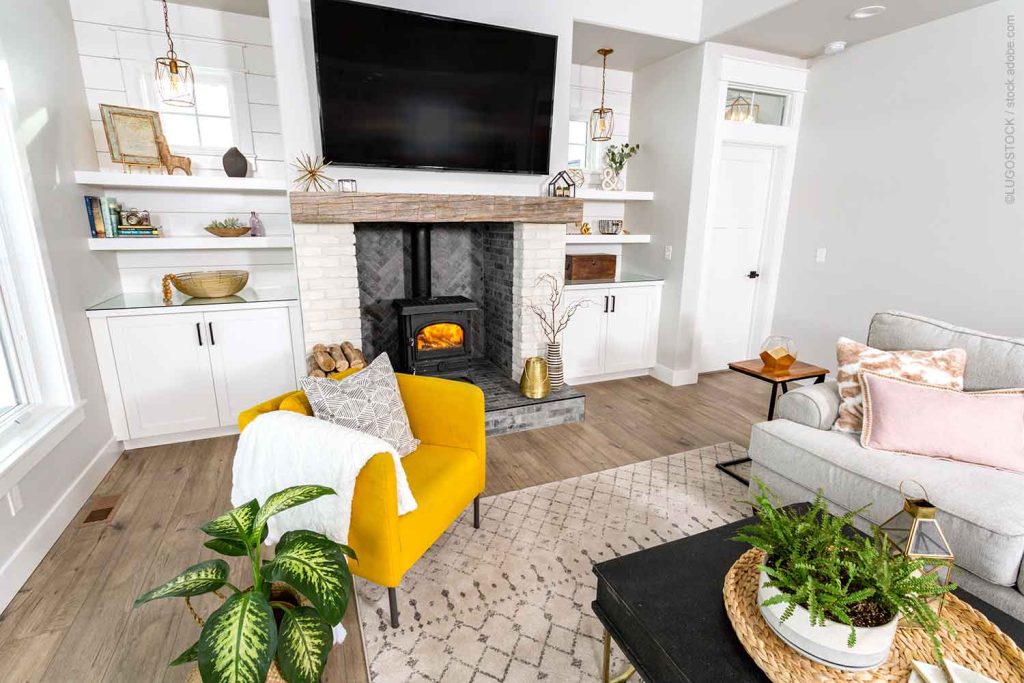 Modern farmhouse with floating mantle over fireplace made from reclaimed wood